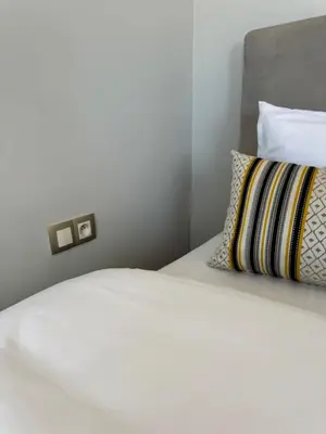 a bedroom with a white bed with a pillow at Ksar Labhar Second Nest in Rabat