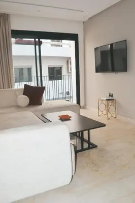 a living room with a couch and a table at Luxueux appartement - Bourgogne, Casablanca in Casablanca