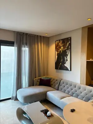 a living room with a couch and a table at Studio Prestige CFC Casablanca in Casablanca