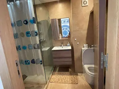 a bathroom with a shower and a toilet and a sink at Appartement en front de mer à 2 pas des Sablettes in Mohammedia