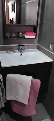 a bathroom with a sink with a mirror and a towel at Appart cozy proche de casa voyageur in Casablanca