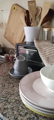 a counter top with plates and utensils on it at Appart cozy proche de casa voyageur in Casablanca