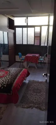 a room with a bed and a table and chairs at المنصورية in Mohammedia