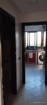an open door to a kitchen with a window at المنصورية in Mohammedia