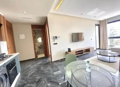 a kitchen and living room with a glass table at Le 134 Square in Casablanca