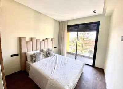 a bedroom with a white bed with a large window at Le 134 Square in Casablanca