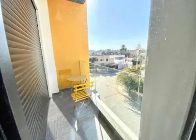 a balcony with a yellow table and yellow chairs on it at Le 134 Square in Casablanca