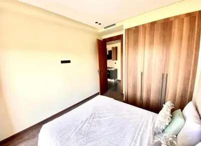 a bedroom with a bed and a wooden wall at Le 134 Square in Casablanca