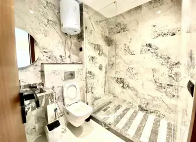 a bathroom with a white toilet and a shower at Le 134 Square in Casablanca