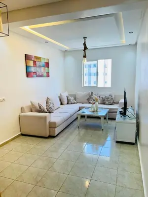 a living room with a couch and a table at Cosy chambre salon à 2 min harhoura in Temara
