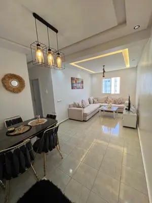 a living room with a couch and a table at Cosy chambre salon à 2 min harhoura in Temara