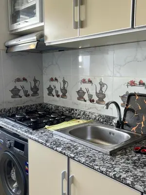 a kitchen with a sink and a stove at Cosy chambre salon à 2 min harhoura in Temara