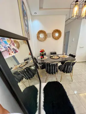 a dining room with a table and chairs at Cosy chambre salon à 2 min harhoura in Temara