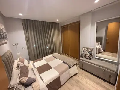 a bedroom with a bed and a large mirror at Cozy studio in ain diab in Casablanca
