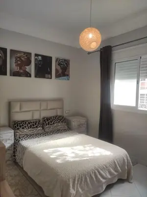a bedroom with a large bed and a window at Mounia Moon in Casablanca