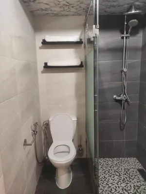 a small bathroom with a toilet and a shower at Mounia Moon in Casablanca