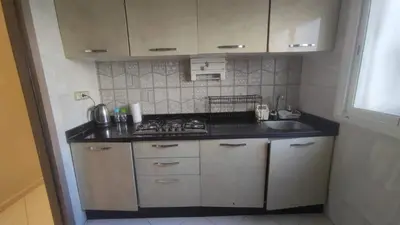 a small kitchen with a stove and a sink at Mounia Moon in Casablanca
