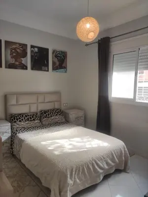a bedroom with a bed and a window and a lamp at Mounia Moon in Casablanca