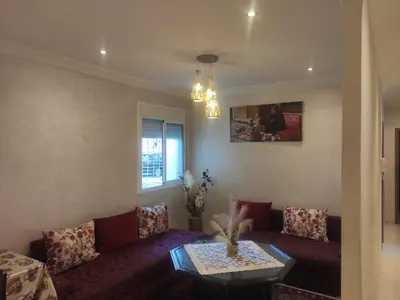 a living room with a purple couch and a table at Mounia Moon in Casablanca