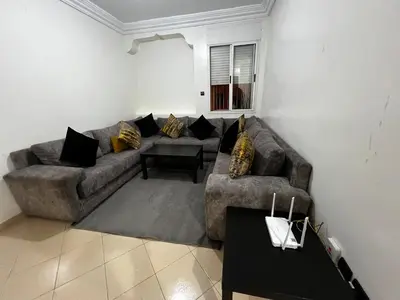 a living room with a couch and a table at Apartment busway nearshore in Casablanca