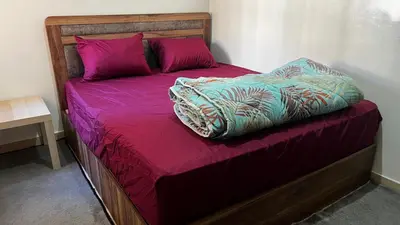 a bed with purple sheets and pink pillows at Apartment busway nearshore in Casablanca