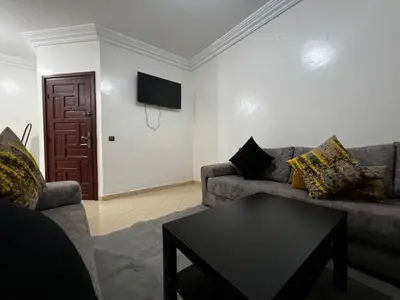 a living room with a couch and a table at Apartment busway nearshore in Casablanca