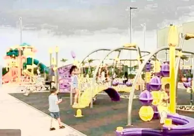 a group of children playing at a playground at Blanca beach in Sidi Rahal