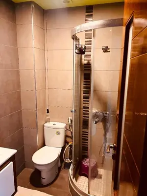 a small bathroom with a toilet and a shower at Blanca beach in Sidi Rahal