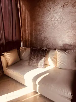 a white couch sitting in a living room at Blanca beach in Sidi Rahal