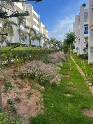 a garden in front of a building at Apparemment pas cher à mohammedia in Mohammedia