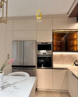a kitchen with stainless steel appliances and wooden cabinets at Villa alex33 in Casablanca