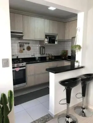 a kitchen with a counter and two bar stools at Villa alex33 in Casablanca