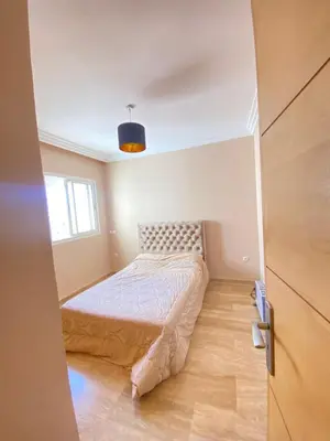 a small bedroom with a bed and a window at La perle bleu face à la mer Rabat in Rabat
