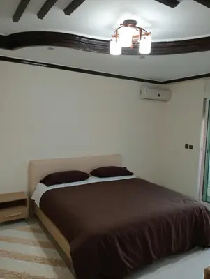 a bedroom with a bed and a chandelier at Beautiful villa Near the beach in Mohammedia