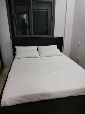 a large white bed with two pillows in a bedroom at Pierro in Maarif