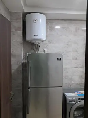 a kitchen with a refrigerator and a white appliance at Pierro in Maarif