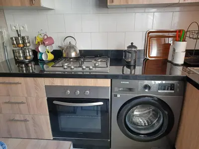 a kitchen with a stove and a washing machine at Lovely & Comfy Long and Short Stay at Nouacer-Casa 2-Bedroom Apartment in Nouaceur