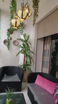 a living room with a couch and a pink pillow at Lovely & Comfy Long and Short Stay at Nouacer-Casa 2-Bedroom Apartment in Nouaceur