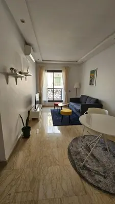 a living room with a couch and a table at Apartment with terrace - Strategic location in Casablanca
