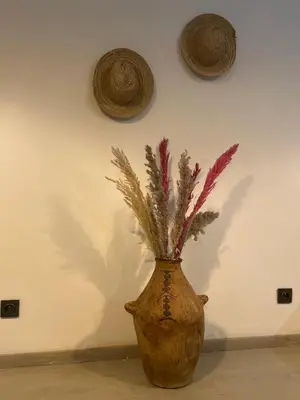 a vase with some flowers in it on a wall at Chez vous au cœur de Casablanca in Casablanca