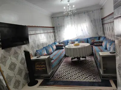 a living room with a couch and a table at Charming Moroccan apartment ground floor 2 bedrooms 1 living room in Casablanca