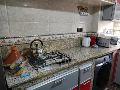 a kitchen counter with a stove top with a tea pot on it at Charming Moroccan apartment ground floor 2 bedrooms 1 living room in Casablanca