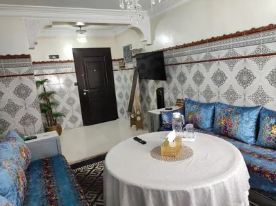 a living room with a table and a couch at Charming Moroccan apartment ground floor 2 bedrooms 1 living room in Casablanca