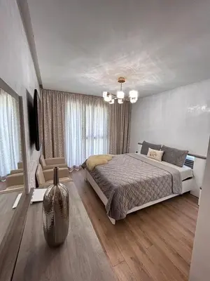a bedroom with a bed and a television in it at le carrousel Residence Rabat in Rabat