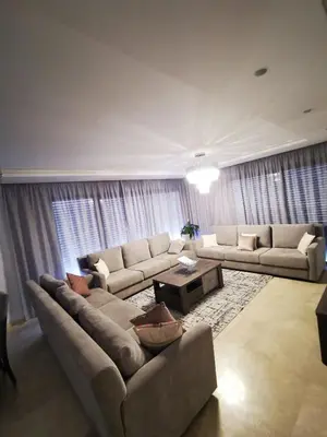 a living room with a couch and a table at le carrousel Residence Rabat in Rabat