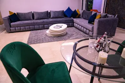a living room with a couch and a glass table at R103- Comfy and Spatious 1 BR Apartment with Breathtaking City View - Belvédère in Casablanca