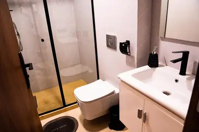 a bathroom with a toilet and a sink and a shower at R103- Comfy and Spatious 1 BR Apartment with Breathtaking City View - Belvédère in Casablanca