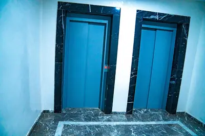 two blue doors in a room with a marble floor at R103- Comfy and Spatious 1 BR Apartment with Breathtaking City View - Belvédère in Casablanca
