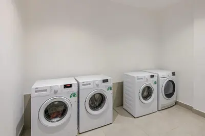 three washing machines and a washer and dryer in a room at VIVASTAY Casablanca - Carpdiem Aliya Residence in Casablanca