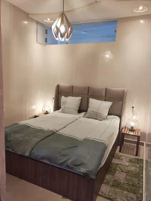 a large bed in a bedroom with two lamps at Apart 3ch 2sdb salon Centre ville in Casablanca